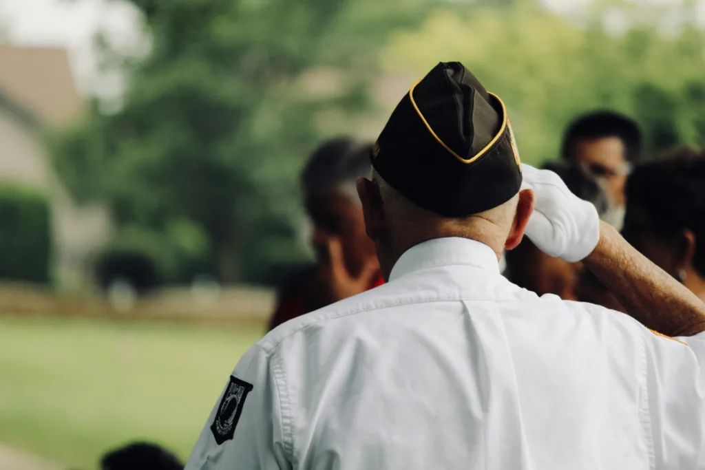 Older Veteran Salutes from behind